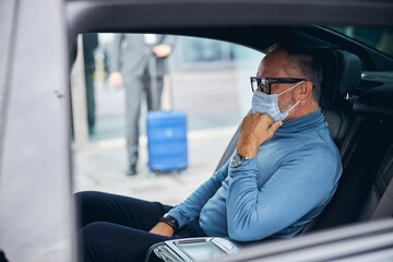 Wall Mural - Pensive male passenger waiting for his driver