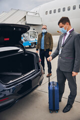 Wall Mural - Passenger staring at a young man with his luggage