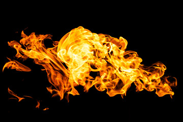 Fire flames on black background isolated. Burning gas or gasoline burns with fire and flames. Flaming burning sparks close-up, fire patterns. Infernal glow of fire in the dark with copy-space