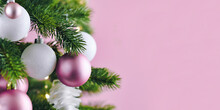 Banner With Christmas Tree Decorated With White And Pink Seasonal Tree Ornament Baubles On Pink Background With Empty Copy Space