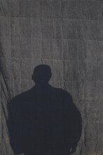 Shadow Of Man On Blue Backdrop