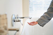 © Trevor Adeline/Caia Image - Woman checking water temperature from soaking tub faucet in bathroom