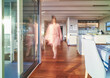 © Trevor Adeline/Caia Image - Blurred woman walking in luxury home showcase interior