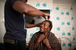 © Himalayan Pics/Caia Image - Uncertain woman receiving haircut from husband at home