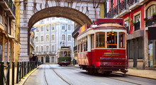 Lisbon, Portugal. Vintage Red Retro Tram On Narrow Bystreet Tramline In Alfama District Of Old Town. Popular Touristic Attraction Of Lisboa City. Public Tramways Trasport.