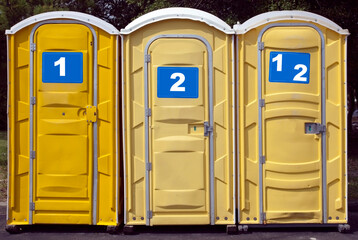 Wall Mural - Portable event latrines numbed 1, 2 and 1 and 2. Humor.