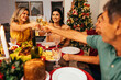 © kleberpicui - Christmas in Brazil. Family toasting at Christmas dinner.