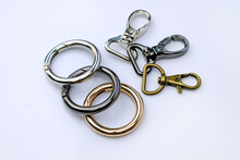 Chrome Metal Carabiners For A Backpack Strap. Round Carabiner For A Woman's Bag. Stylish Chrome Fittings. Bag Accessories Metal Clip Buckle. Key Ring With Clipping Path.