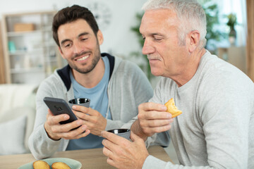 smiling senior man with his grown up son