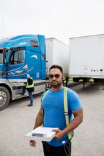 Trucker Holding Paperwork For Container Semi Truck