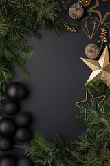 Canvas Print - Christmas top view glamour layout frame made with baubles, fir branches and golden star on dark black background. Minimal winter or New Year concept with copy space. Flat lay, top view, greeting card.