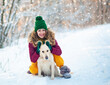 © trofalena - Image of young girl with her dog white golden retriever hugging, outdoor at winter time. Domestic pet. woman playing with dog. Closeup portrait