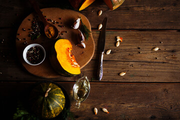 pumpkins with spices and greenery on the table  .ingredients for soup or other pumpkin dishes.healthy organic food .top view