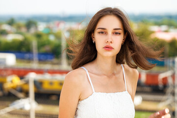 Wall Mural - Close up portrait of a young beautiful girl in summer park