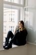 © Javier D√≠ez/Stocksy - Dreamy lady with mug near window