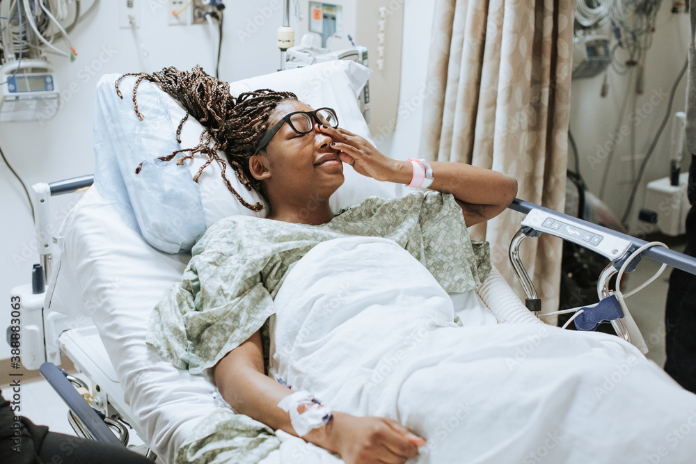 Woman Stressed, Crying in Hospital Bed Stock Photo | Adobe Stock