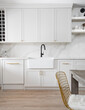 © Lauren Miller/Stocksy - Farmhouse sink in updated kitchen