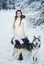 Elegant Woman Posing With Dog At Camera In Winter.
