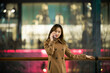 © Makingultimate Xiao/Stocksy - A beautiful Chinese beauty is outside the shopping center at night
