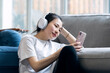 © Makingultimate Xiao/Stocksy - A Chinese beauty is listening to music on her mobile phone