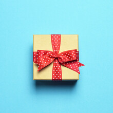 Christmas Gift On Pastel Blue Background. Minimal Flat Lay Christmas Concept
