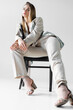© LIGHTFIELD STUDIOS - young trendy woman in suit and stylish shoes on blurred foreground