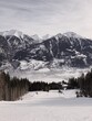 © Julia Semashko/Stocksy - A view on a skiing slope and mountains range in a distance