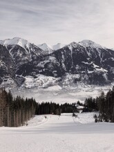 A View On A Skiing Slope And Mountains Range In A Distance