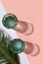 Studio Shot Of Palm Leaves And Two Glasses Of Carbonated Water