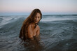 © Gala Martínez López/Westend61 - Young woman enjoying in water at beach