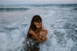 © Gala Martínez López/Westend61 - Young woman taking bath in sea during sunset