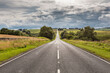 © William Perugini/Westend61 - Clouds over empty countryside highway at dawn