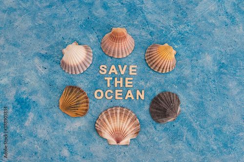 save the ocean text on blue bakground with sea shells, act for climate change concept