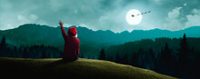 Boy Waving To Santa Claus Over The Hill On Beautiful Christmas Night