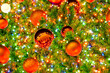 © Dmitrii - christmas tree decorated with red balls and glowing garlands in warm colors, selective focus