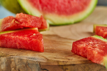 Sticker - Mini Watermelon with sliced wedges on a light board on a light blue background