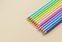 A Set Of Pencils For Drawing Pastel Colors On A Light Background
