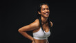 © Jacob Lund - Smiling fit woman on black background