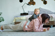 © yavdat - young mom does the plank when her daughter sits on her back
