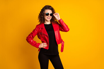 Sticker - Portrait of her she nice-looking cheerful cool wavy-haired girl wearing eco leather coat touching specs isolated on bright yellow color background