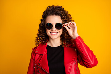 Wall Mural - Close-up portrait of her she nice pretty cheerful fashionable wavy-haired girl touching round specs isolated on bright vivid yellow color background