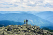 © anatoliy_gleb - Back view couple tourists holding hands and enjoying powerful view. Man and woman is standing on top of cliff under the sky with cumulus clouds