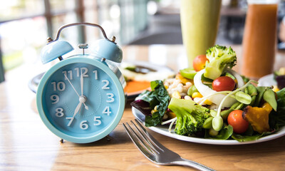 Selective focus with Blue clock breakfast time and Intermittent fasting ,Lifestyle concept.