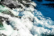 Wild And Fast Moving River Rapids White Water Rushing Over Rugged Cliffs. Close Up.