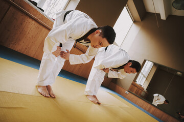 Wall Mural - Two martial arts students training doing karate.