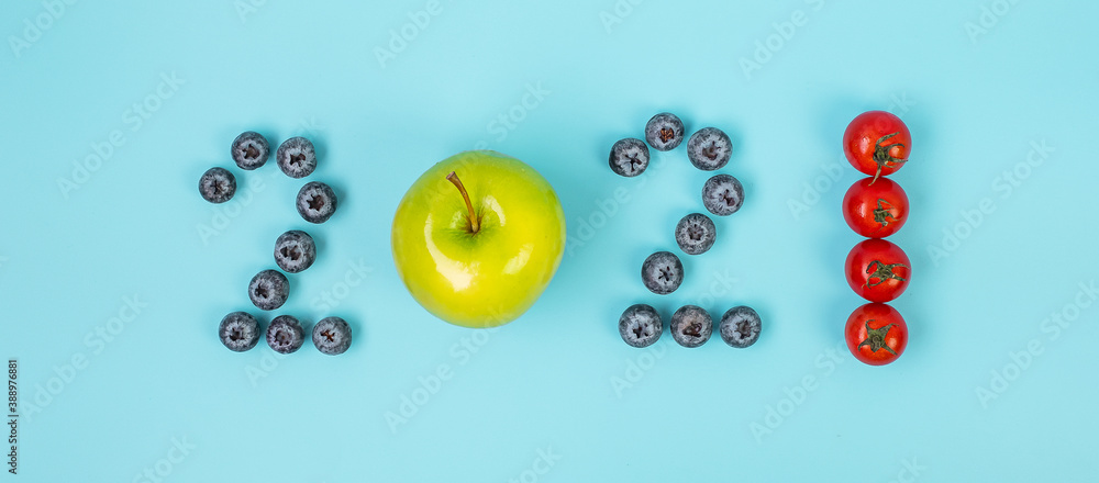 2021 Happy New Year and New You with fruit and vegetable; Blueberries, green apple and Tomato on blue background. Goals, Healthy, Resolution, Time to New Start and dieting concept - obrazy, fototapety, plakaty 
