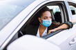 © maxbelchenko - Young woman in protective medical mask driving a car. Safety during coronavirus pandemic, epidemic covid-19. Transport isolation.