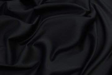 Wall Mural - Smooth elegant black silk satin fabric texture  as abstract background. Luxurious pattern for design.