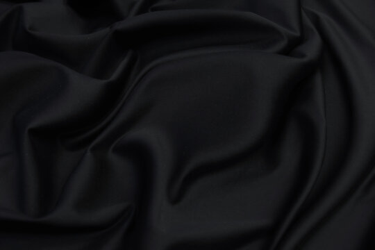 Wall Mural -  - Smooth elegant black silk satin fabric texture  as abstract background. Luxurious pattern for design.