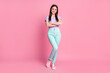 © deagreez - Full length photo of charming business lady good positive mood hands arms crossed self-confident boss person wear casual violet t-shirt teal pants shoes isolated pink pastel color background